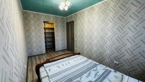 a bedroom with a bed and a book shelf at Vinnytsia, Vyshenka in Vinnytsya +7 photos