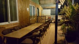 a long wooden table and chairs in a restaurant at Gyeongju Eowoolim Pension in Gyeongju
