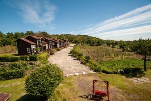 an aerial view of a house with a driveway at Sumang Pension in Seogwipo
