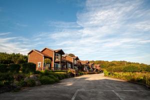 a row of houses on a road at Sumang Pension in Seogwipo