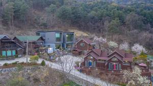 an aerial view of a house in the mountains at Fortune Rising Sun Hill Pension in Pocheon +4 photos