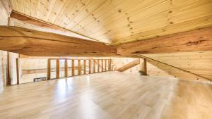 a large room with wooden ceilings and a wooden floor at Muju Moonriver Pension in Wŏnsamgŏri