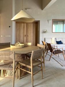 a dining room with a wooden table and chairs at Binilua in Binibeca