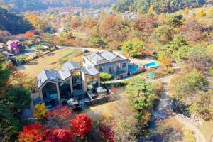 an aerial view of a large house in the woods at Wonju Cloud Pension in Wonju