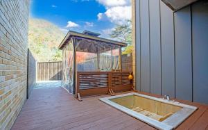 a hot tub on a deck with a gazebo at Wonju Cloud Pension in Wonju