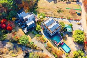 an aerial view of a house with a yard at Wonju Cloud Pension in Wonju +21 photos