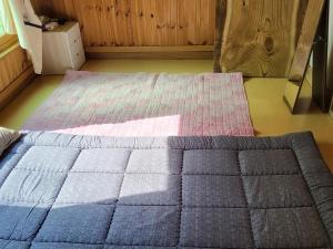 a large bed in a room with a bedspread at Geoje Milky Way Pension in Geoje +3 photos