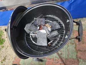 a grill with a bunch of charcoal in it at Gyeongju Heimisch Pool Villa in Gyeongju