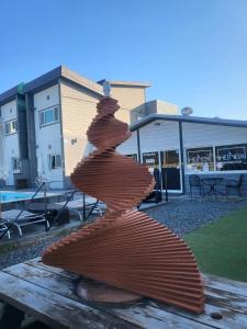 a wooden sculpture of a wooden surfboard on a picnic table at Gyeongju Heimisch Pool Villa in Gyeongju +24 photos