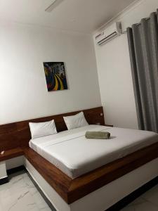 a bedroom with a bed with white sheets and a window at Paje staycation apartment in Paje