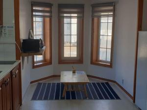 a living room with a table and some windows at Pyeongchang underhill pension in Pyeongchang