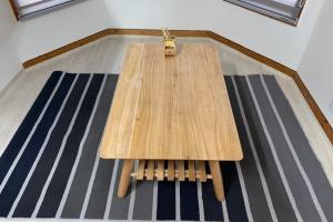 a wooden table sitting on top of a floor at Pyeongchang underhill pension in Pyeongchang
