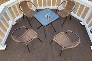 a table and four chairs on a deck at Pyeongchang underhill pension in Pyeongchang +10 photos