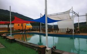a swimming pool with a tent in the middle of it at Jnj Village in Suncheon