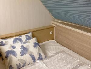 a small room with a bed and a pillow at Jnj Village in Suncheon +49 photos