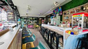 a bar with green walls and chairs in a restaurant at Lamai Hotel in Patong Beach