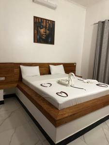 a bedroom with a bed with a phone on it at Paje staycation apartment in Paje +7 photos