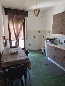 a kitchen with a wooden table and a kitchen with a sink at Villa Cantalupo 1 in Sillavengo
