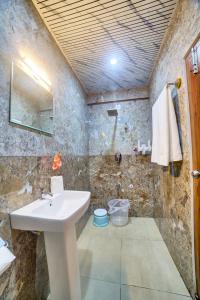a bathroom with a sink and a stone wall at Hotel Airline Inn - Near Kempegowda International Airport in Muthugadahalli +47 photos