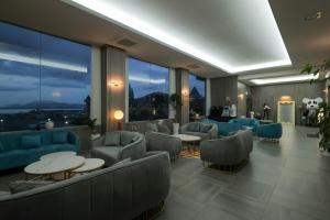 a lobby with couches and tables and large windows at CL Hotel in Boryeong