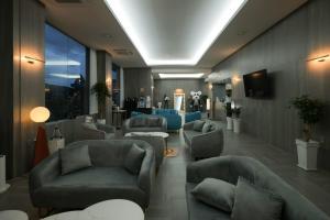 a waiting room with couches and chairs in a hospital at CL Hotel in Boryeong