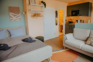 a living room with a bed and a couch at sleepArt cozy in Celle