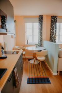 a kitchen with a table and chairs in a room at sleepArt cozy in Celle +12 photos