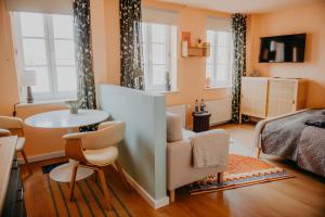 a bedroom with a bed and a table and chairs at sleepArt cozy in Celle