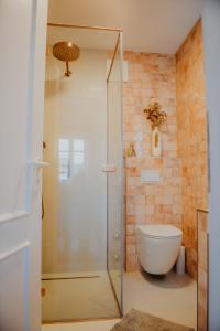 a bathroom with a glass shower with a toilet at sleepArt cozy in Celle