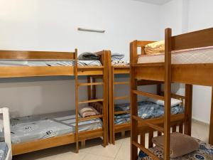 a room with three bunk beds in a room at Exeas Hostel in Vlorë