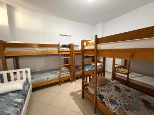 a dorm room with two bunk beds and a bed at Exeas Hostel in Vlorë