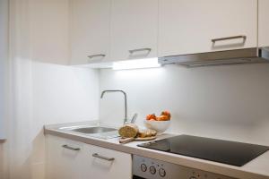 a kitchen with a sink and a bowl of fruit at Villa Sabine in Merano