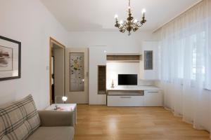 a living room with a couch and a television at Villa Sabine in Merano