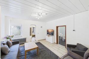 a living room with a couch and a table at Ankas Ferienwohnung 2 in Bexbach
