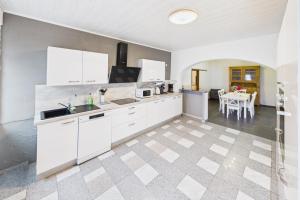 a kitchen with white cabinets and a dining room at Ankas Ferienwohnung 2 in Bexbach +1 photo