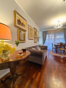 a living room with a couch and a table at Al Colosseo Quadrato in Rome