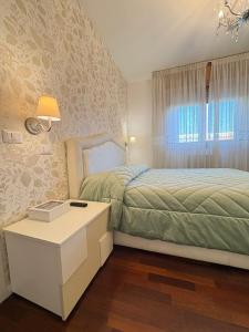 a bedroom with a bed and a table and a window at Al Colosseo Quadrato in Rome