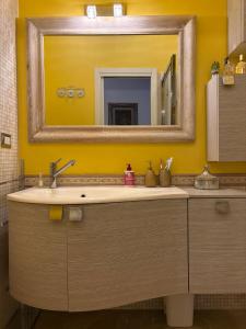 a bathroom with a sink and a mirror at Al Colosseo Quadrato in Rome +23 photos