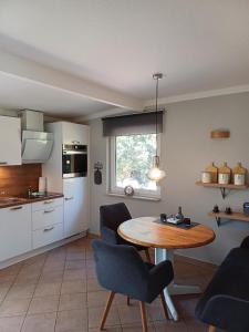 a kitchen with a table and chairs in a room at Gemütliches Häuschen am Fleesensee in Göhren-Lebbin