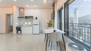 a kitchen with white appliances and a balcony at Gapyeong Zav Pool Villa in Gapyeong