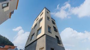 a tall white building with a sky in the background at Gapyeong Zav Pool Villa in Gapyeong