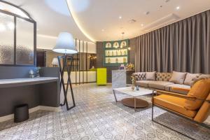 a living room with a couch and a table at Gimhae Eobang-Dong Nomad Hotel in Gimhae