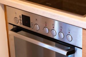 a stove top oven with a microwave on top of it at Venetia Luxurious Villa in Iraklitsa