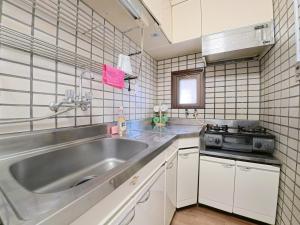 a kitchen with a large sink and a stove at サムティ扇町 in Osaka +241 photos