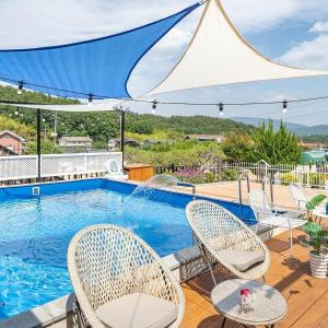 a patio with chairs and a swimming pool at Gyeongju Areum Maru in Gyeongju