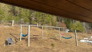 a group of swings in a yard at Pensiunea Izabel in Lacu Rosu