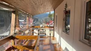 a hallway with benches and a view of a mountain at Pensiunea Izabel in Lacu Rosu