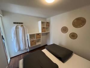 a small bedroom with a bed and some shelves at Wellness in de NATUUR in Neede