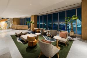 a hotel lobby with a view of the city at Hilton Garden Inn Yokohama Minatomirai in Yokohama