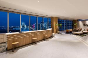 a hotel lobby with a view of the city at Hilton Garden Inn Yokohama Minatomirai in Yokohama +80 photos